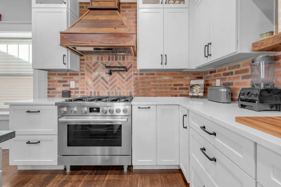 Kitchen detail with brick backsplash and custom range hood, Denver, CO